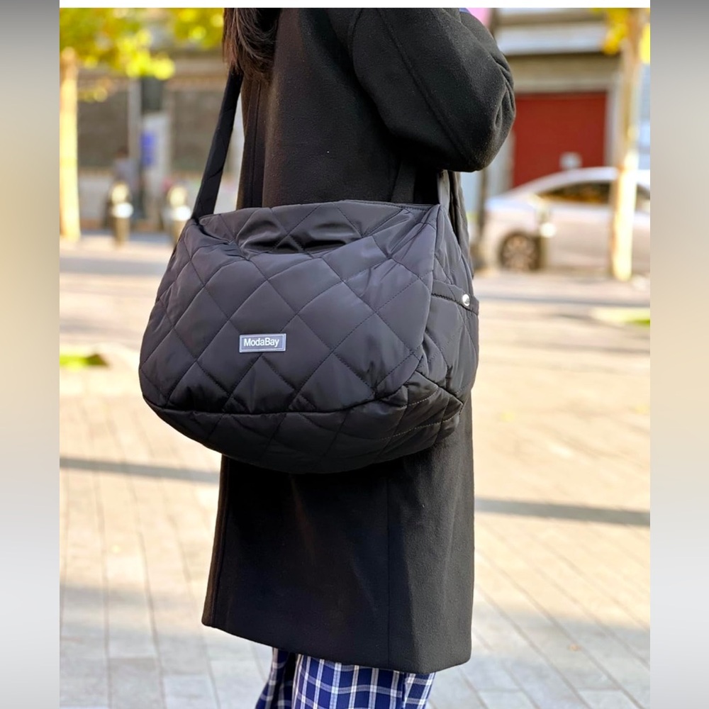 Black Quilted Puffer Crossbody Bag. Zipper close with snap close end pockets.